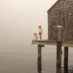 Photo of two children on a tall dock