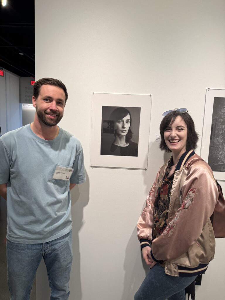 Lindsey Kaiser and his muse next to his award-winning image, "Her Gaze"
