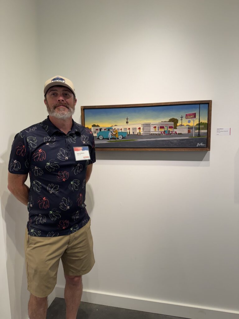 Jason Williams with his award-winning piece "Hard Traveling on Route 66"